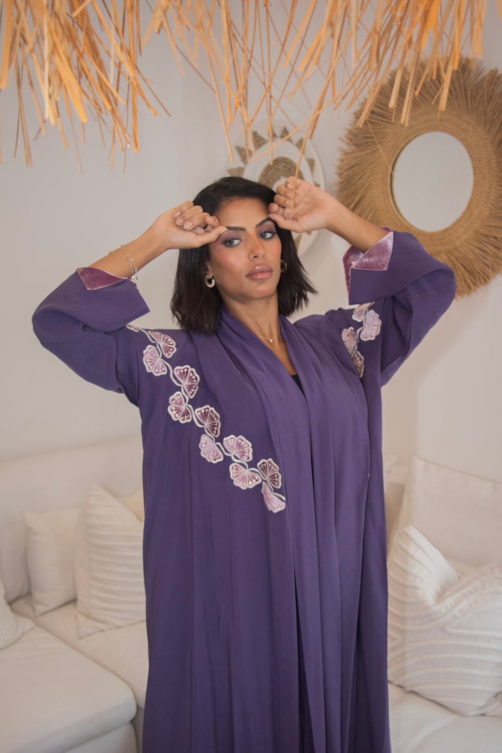 Close-up of PEONISA Amethyst purple abaya showing floral embroidery across the shoulder and sleeve.
