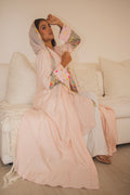 PEONISA Bloom with Grace light pink abaya with multicolor patterned trim along the front opening and cuffs.