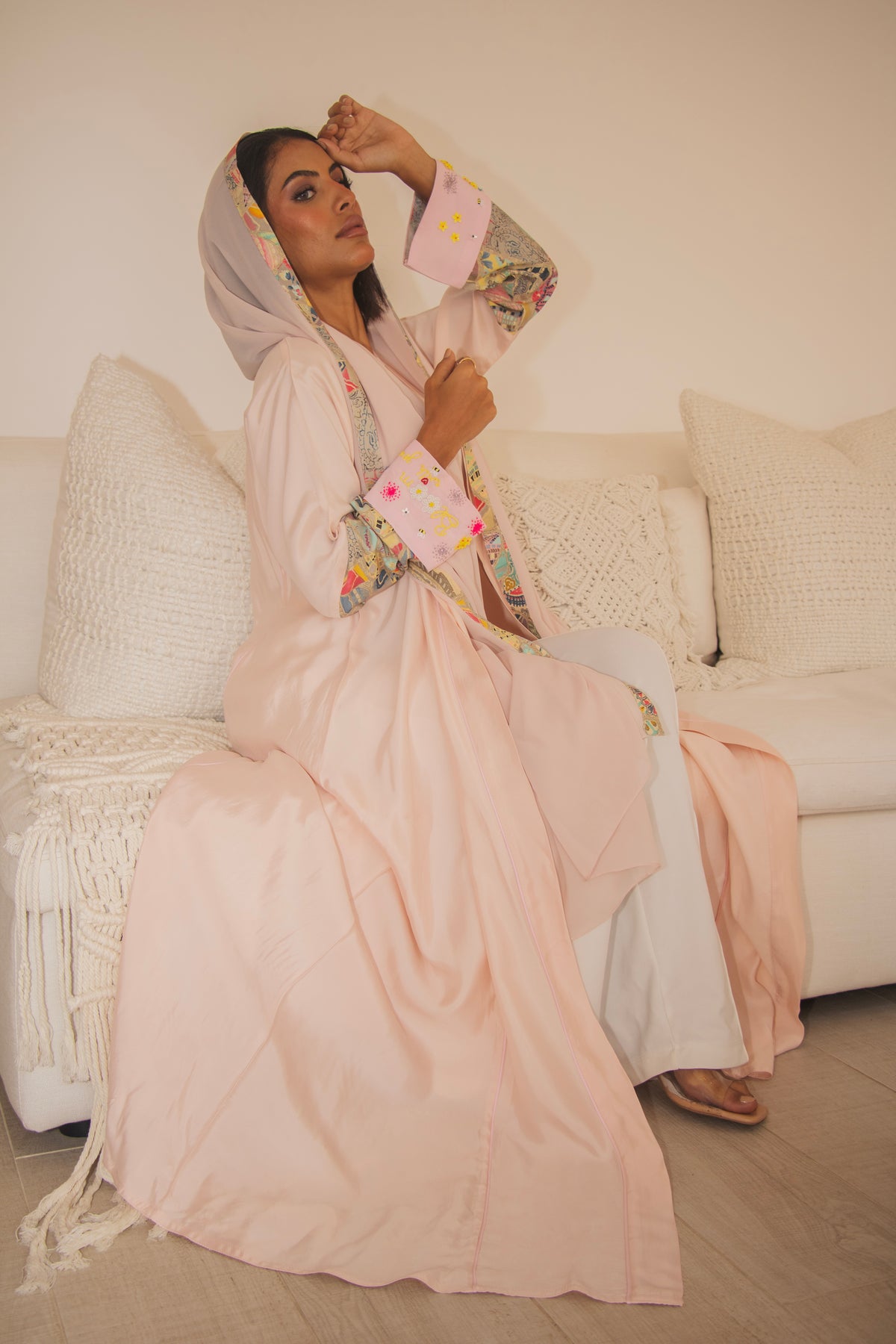 PEONISA Bloom with Grace light pink abaya with multicolor patterned trim along the front opening and cuffs.