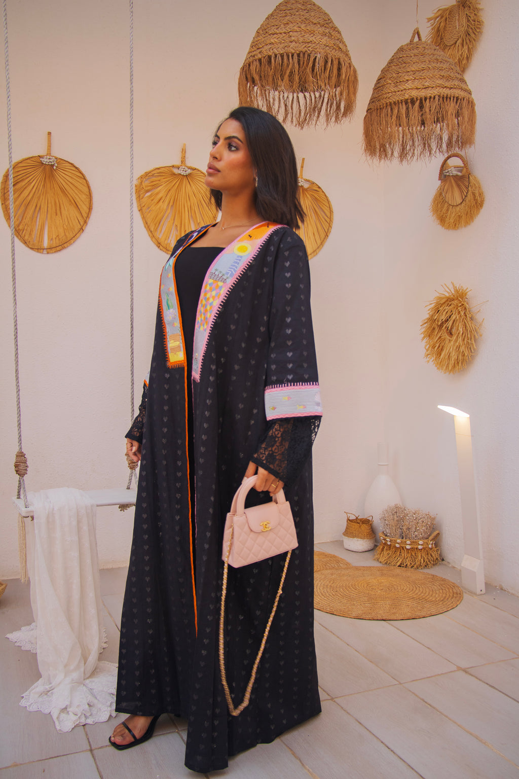 PEONISA Jeddah Corniche black abaya with colorful embroidered front panels, patterned sleeves and contrast trim.