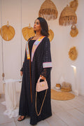 PEONISA Jeddah Corniche black abaya with colorful embroidered front panels, patterned sleeves and contrast trim.