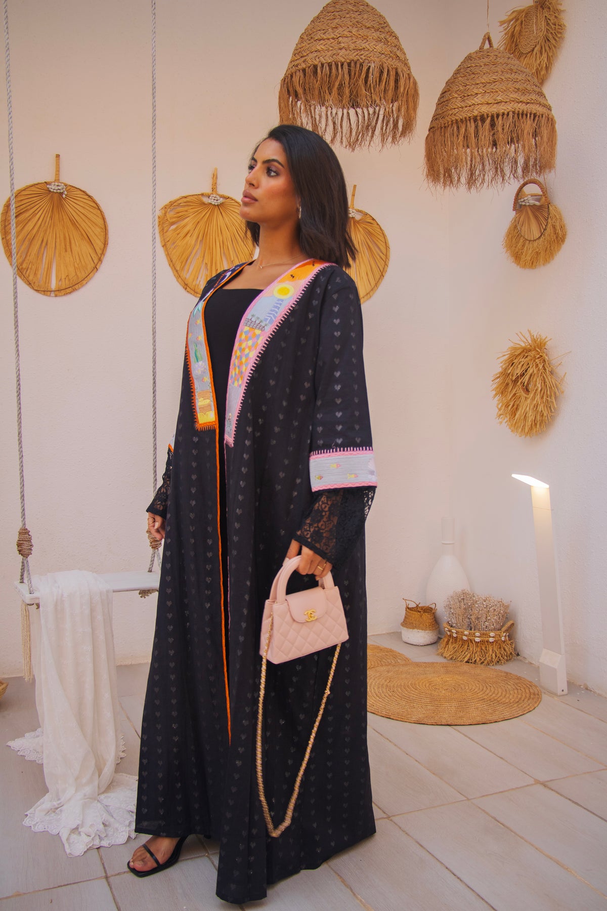 PEONISA Jeddah Corniche black abaya with colorful embroidered front panels, patterned sleeves and contrast trim.