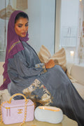 PEONISA Misk grey abaya with gold and soft pink embroidered details along the sleeve and side panel.