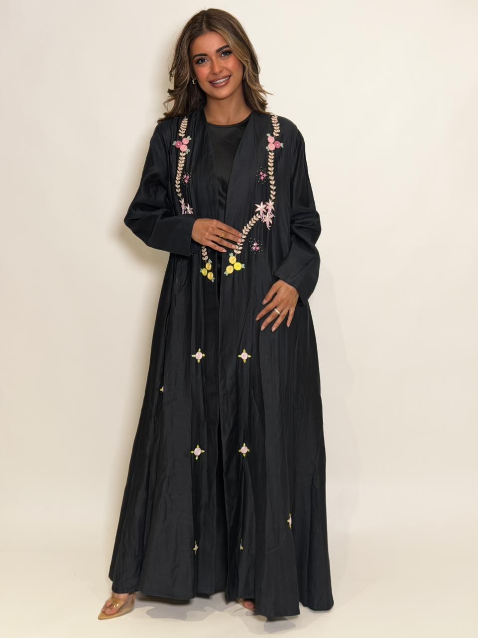 Rawd black abaya with delicate hand embroidery in pink, yellow and ivory details.