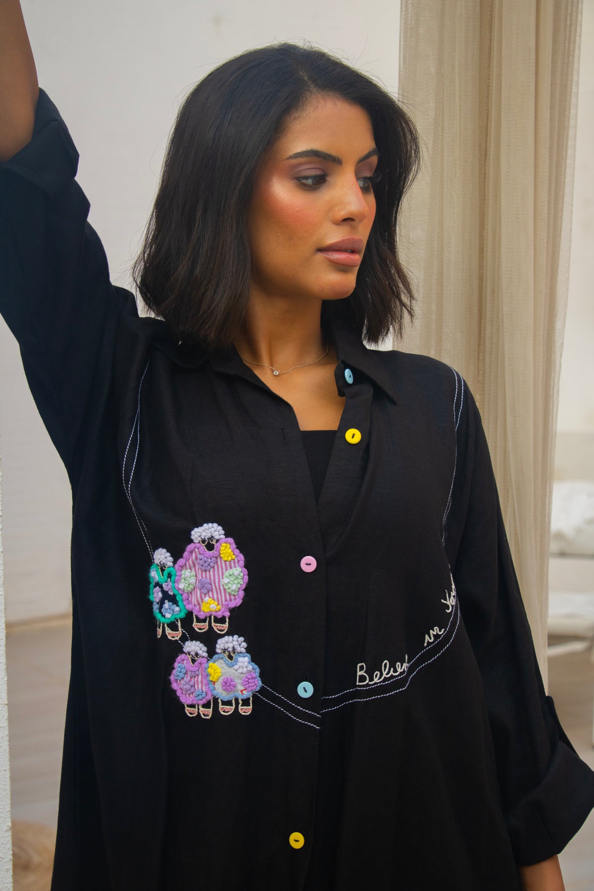 PEONISA Rifq black abaya with colorful embroidered motifs, contrast stitching and multicolor buttons
