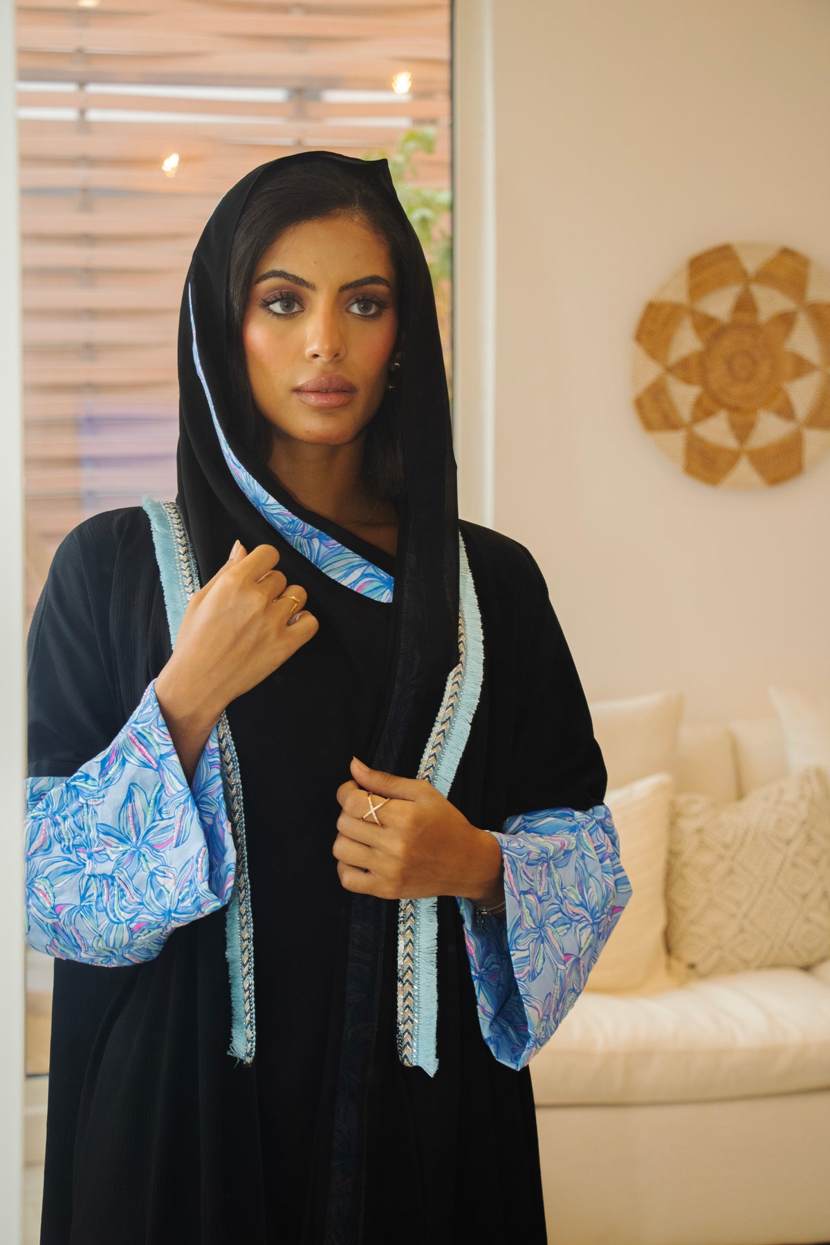 PEONISA Zellige black abaya with blue patterned sleeves and contrasting blue trim along the front opening.